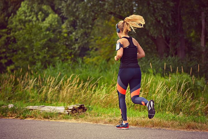 Solo female runner jogging trought a park