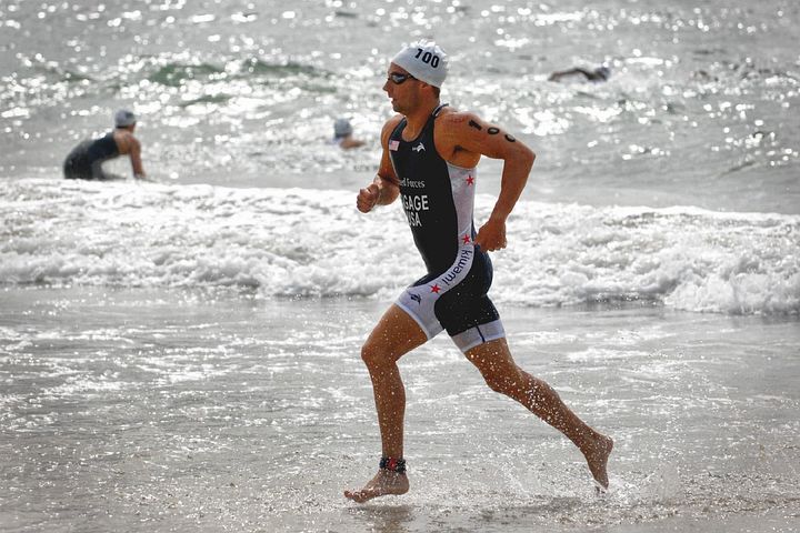 Solo male runner jogging on a beach