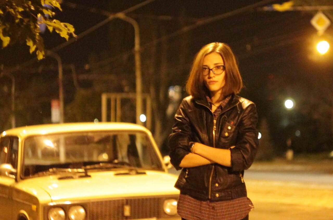 Girl in front of the car in the night